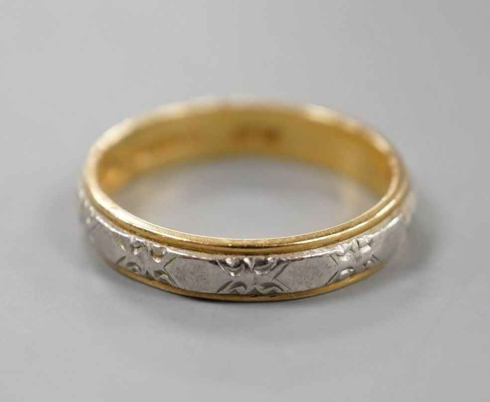 A modern 18ct two colour gold band, size L